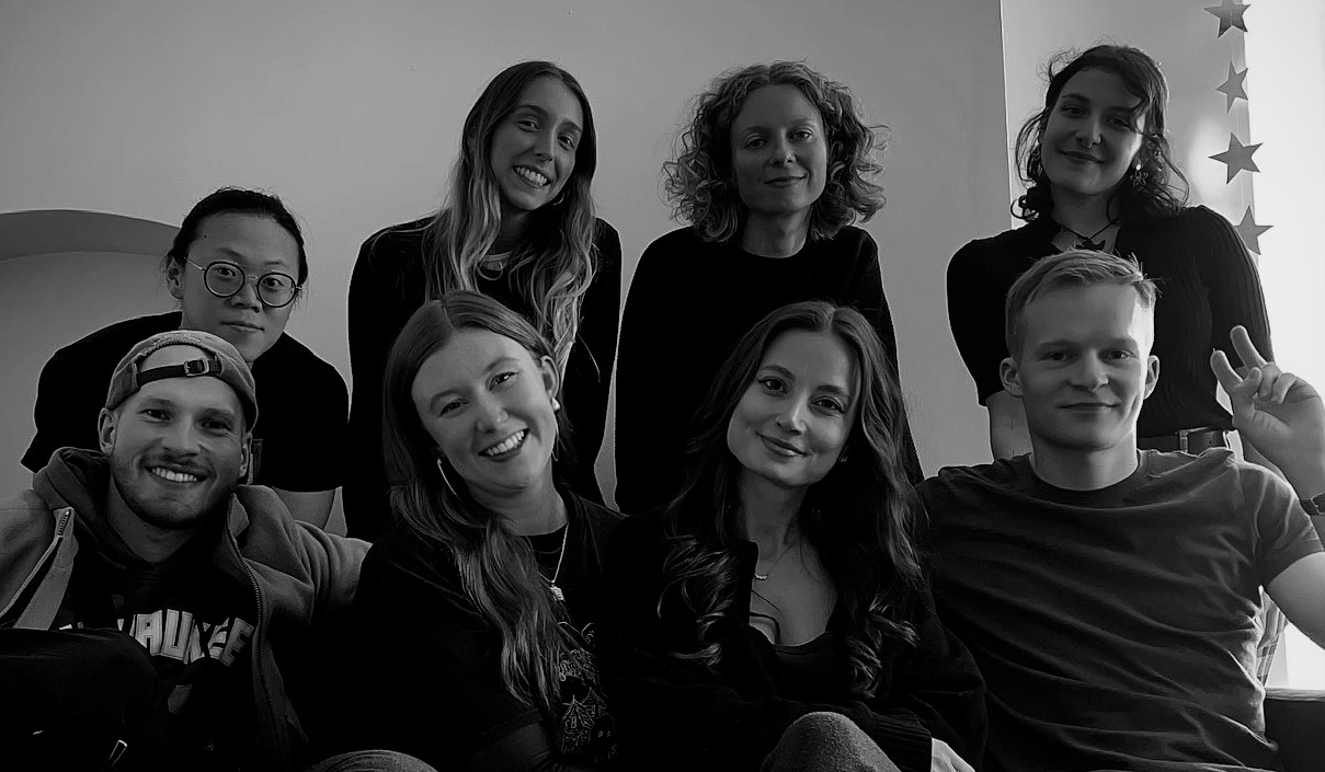 Eight students smiling towards camera